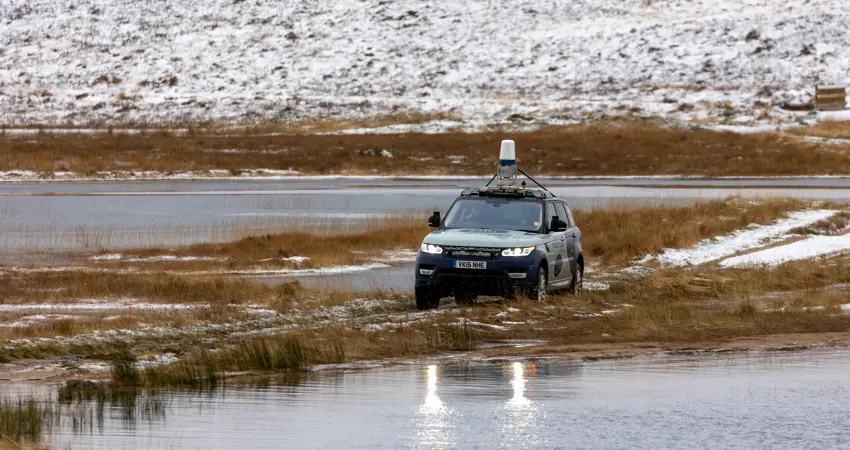 JLR Car crossing watery causeway.
