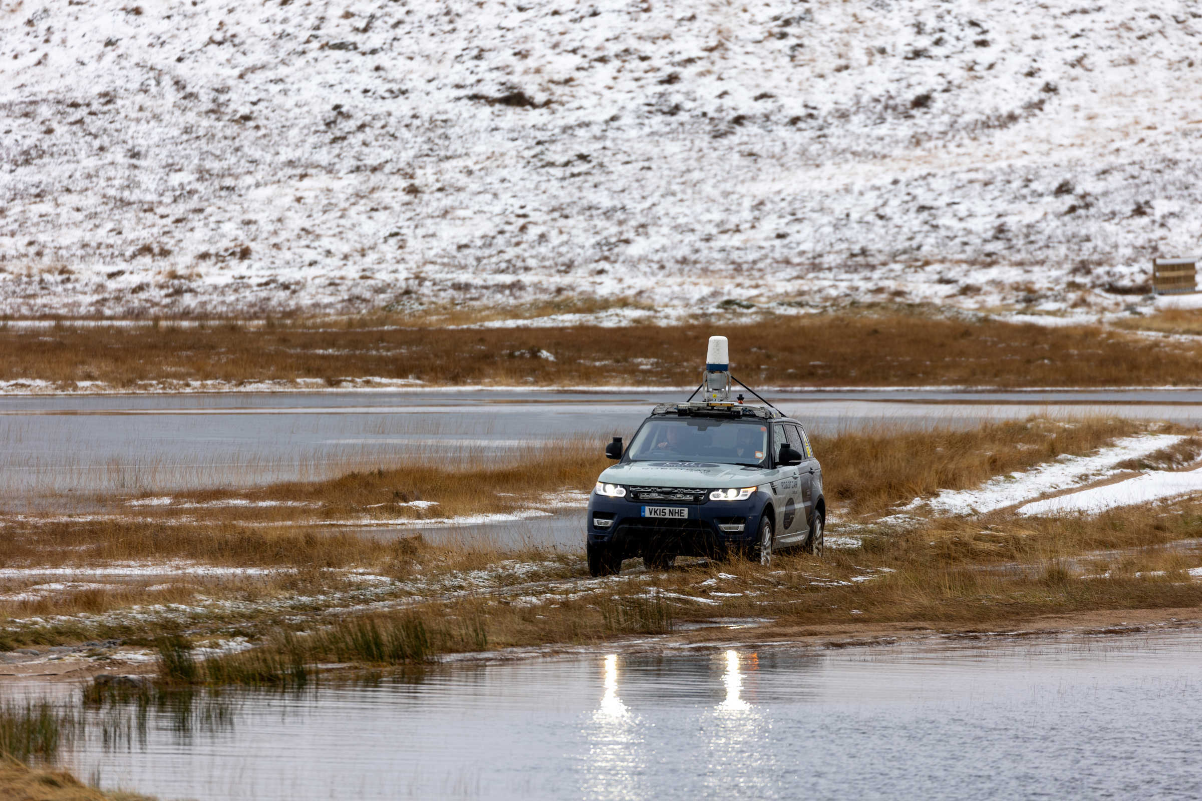 JLR Car crossing watery causeway.