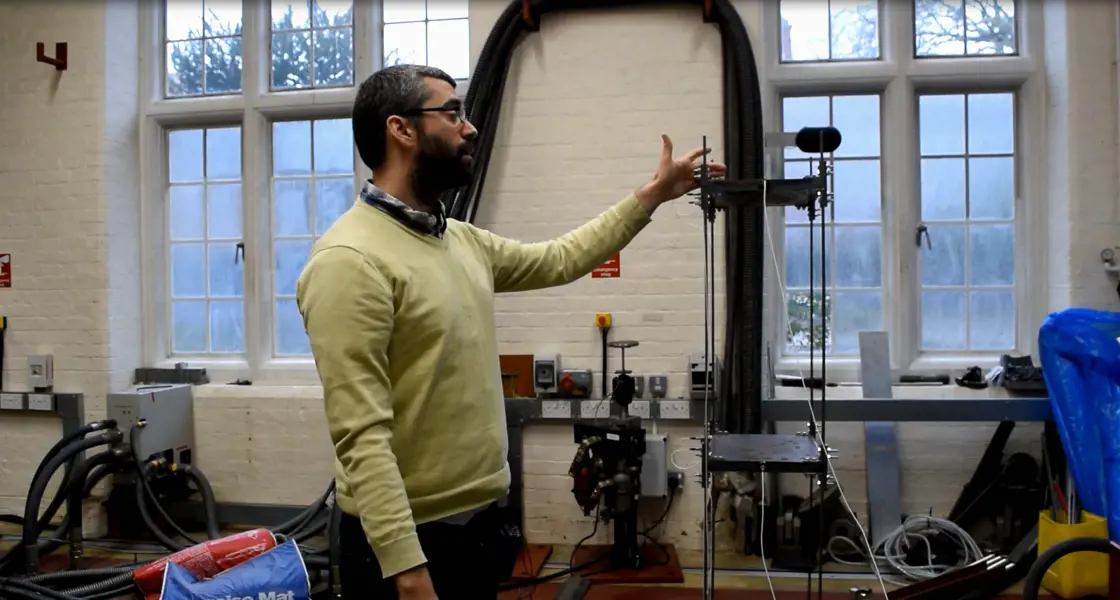 Man demonstrating shake table at Oxplore event