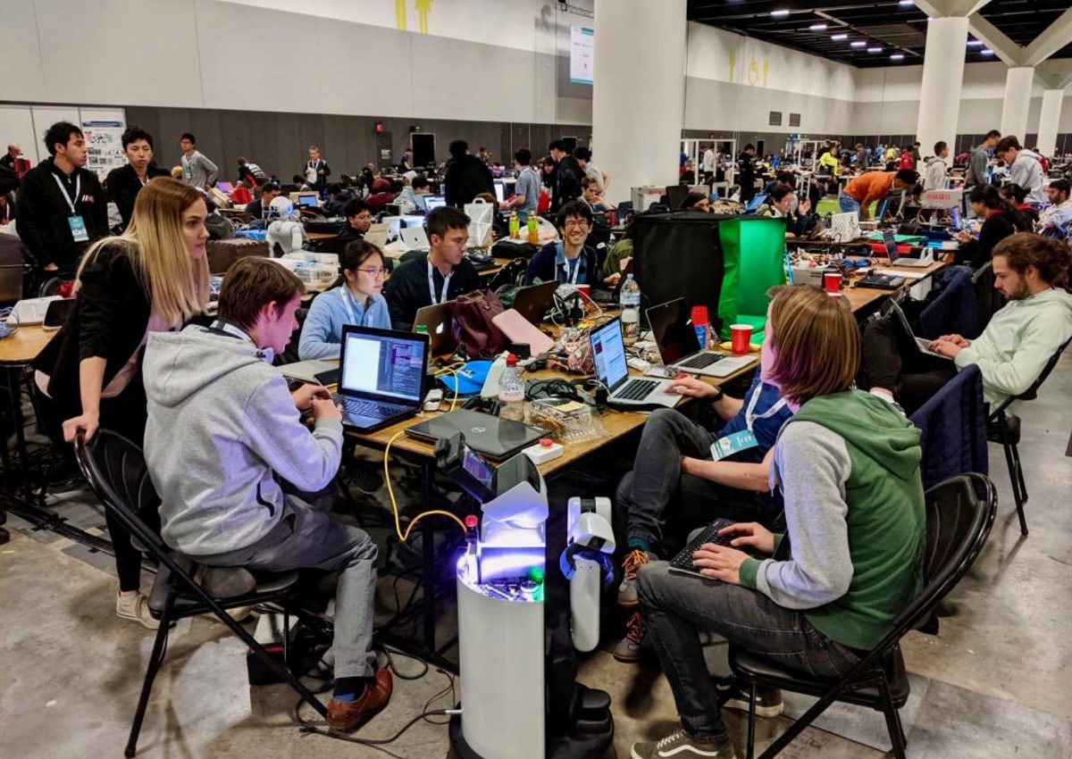Large room of people working on computers at Robocup 2019