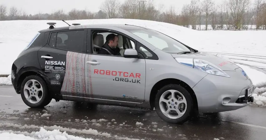 A robot car driving in the rain