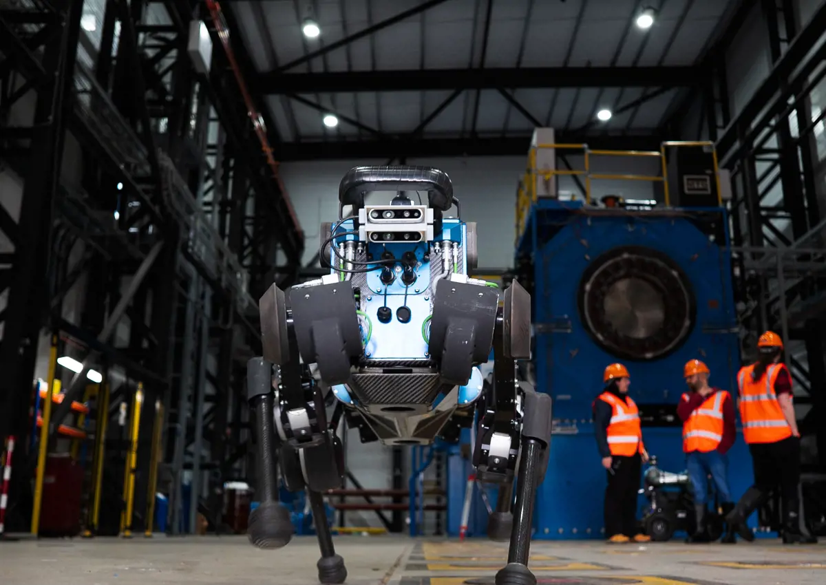 blue ANYmal B robot, standing in industrial site. 