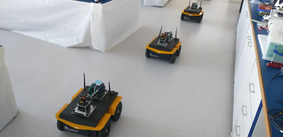 Multi-robot experiment conducted by Charlie Street as part of his research into congestion-aware robots. Jackal robot platform.