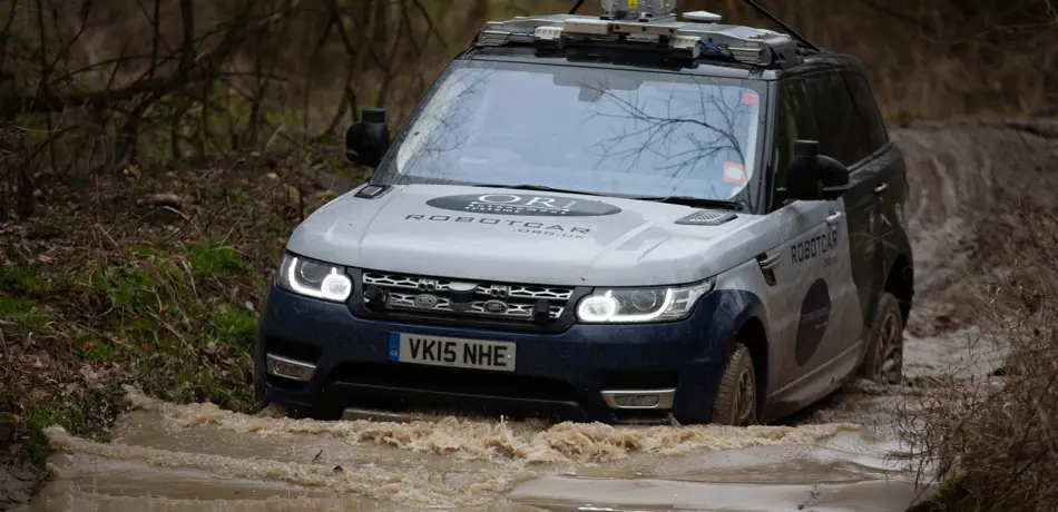 JLR vehicle driving through water.