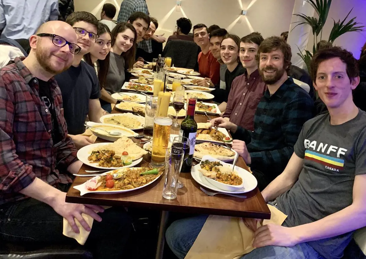 GOALS group sitting at dinner table for group outing. 