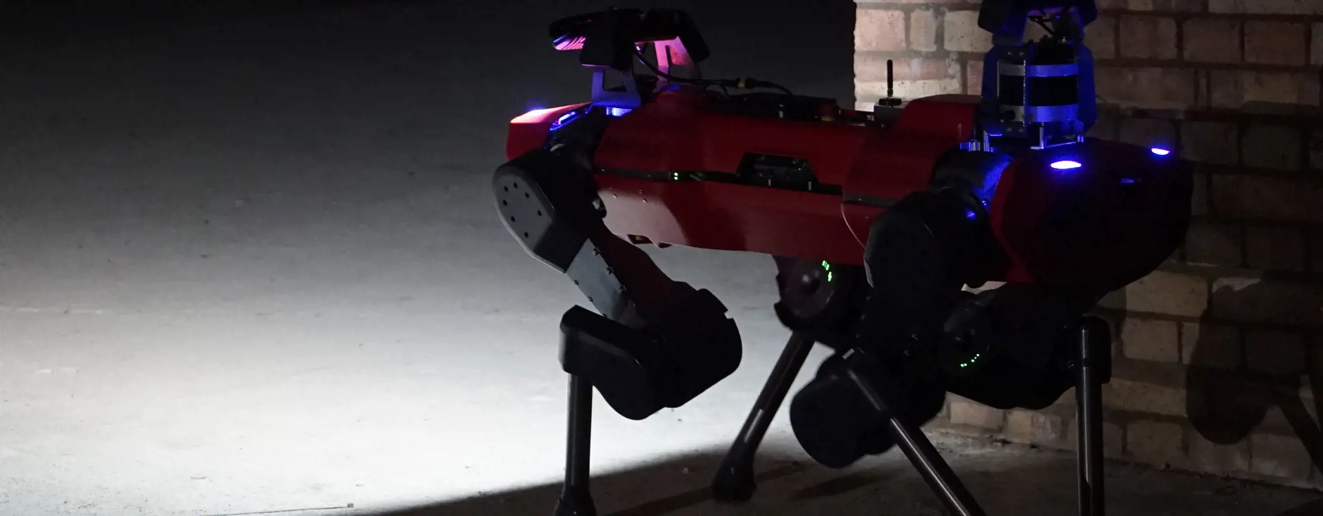 Red anymal c robot surveying dark underground site. 