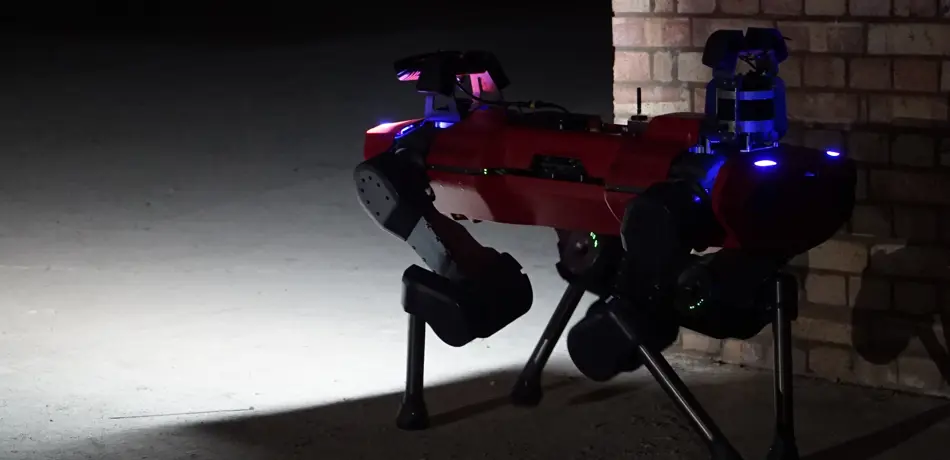 Red anymal c robot surveying dark underground site.