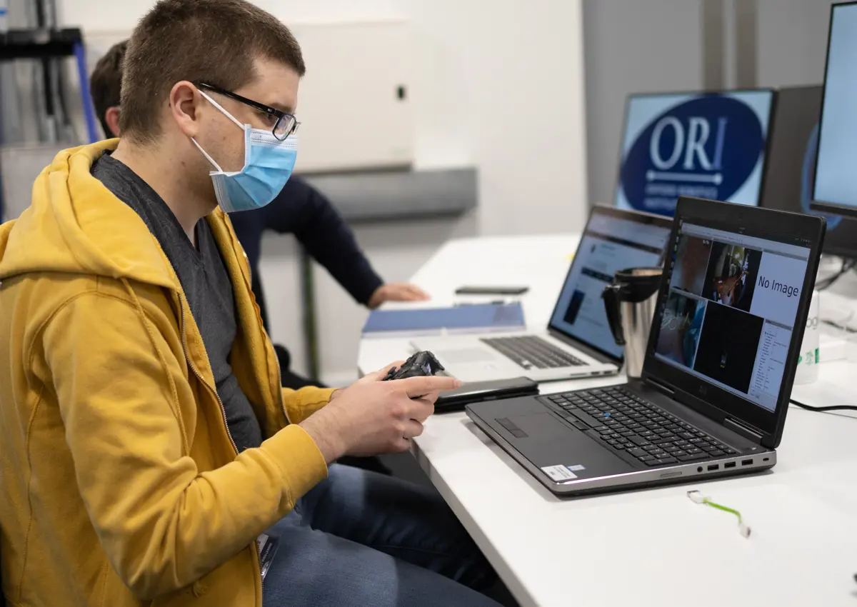 ORI operator remotely controlling robot.