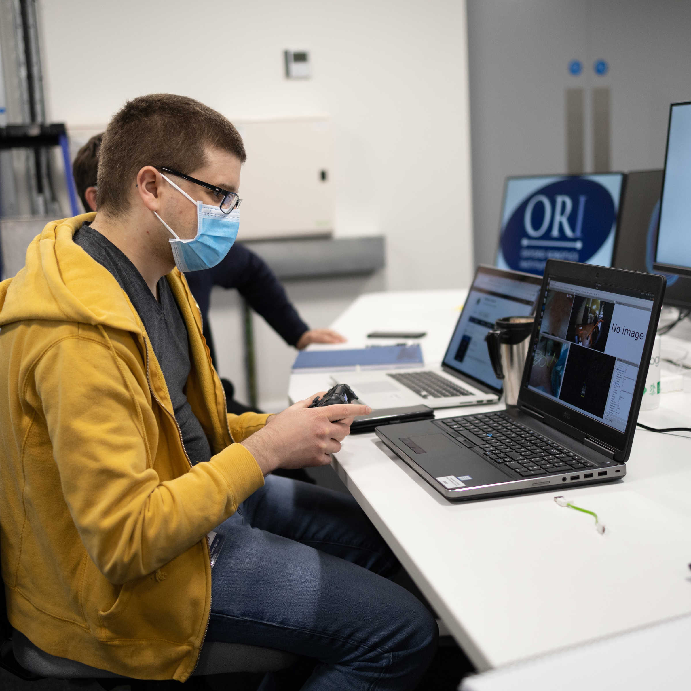 ORI operator remotely controlling robot.