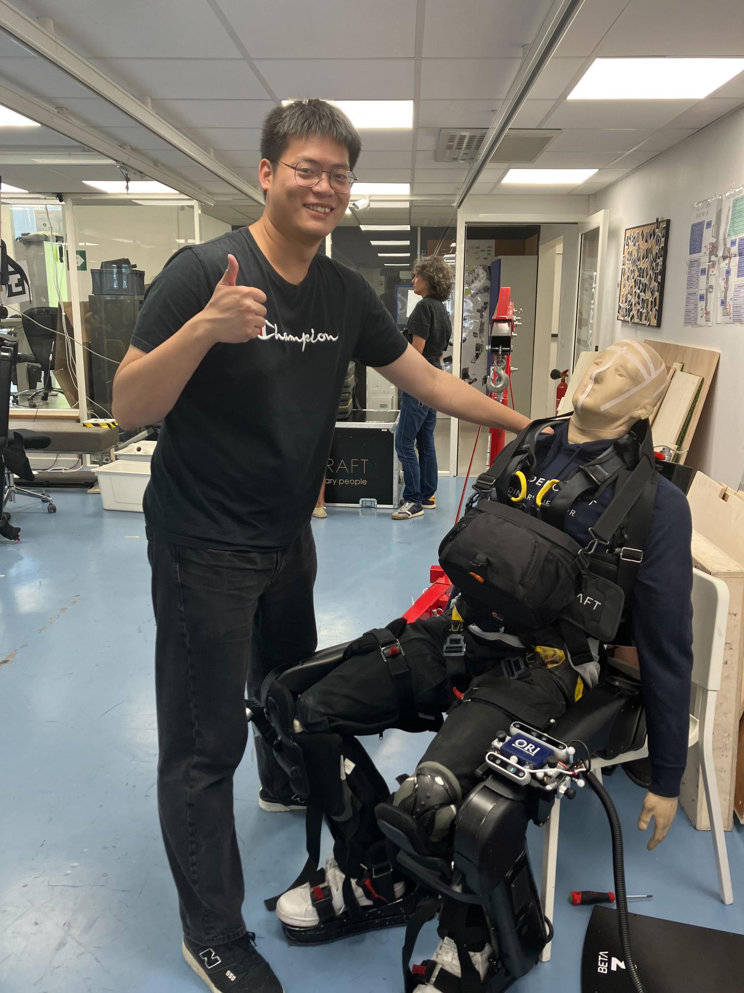 Jianeng Wang with manikin wearing an exoskeleton used to test the Exosense system during a research visit to Wandercraft in Paris